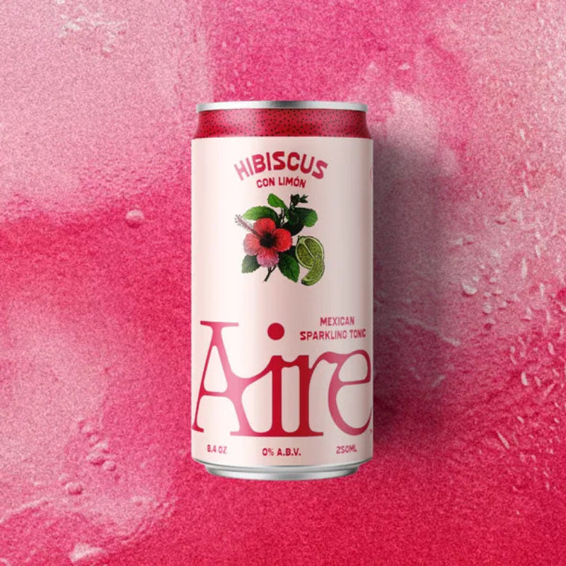 Aire canned drink on a pink textured background