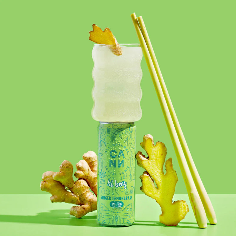 Ginger lemonade with ginger root and a pineapple slice on a green background