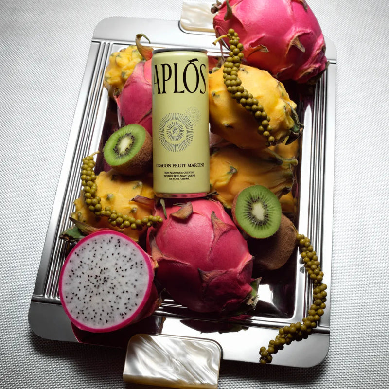 Bottle of Aplos with dragon fruit and other fruits on a tray