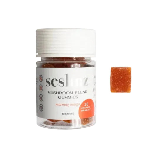 A small clear jar of Seshitz Mushroom Blend Gummies with a white cap and white label, shown next to a single orange-brown gummy on a plain white background.