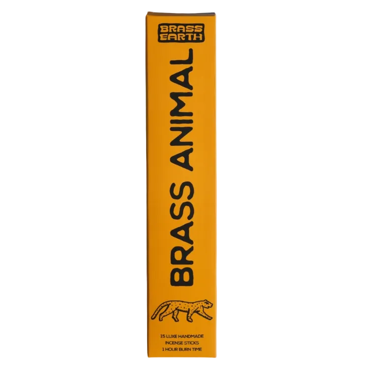 A tall, narrow yellow-orange product box standing upright on a light gray background. The box has black text reading 'BRASS ANIMAL' and 'BRASS EARTH,' plus a small black animal silhouette near the bottom.