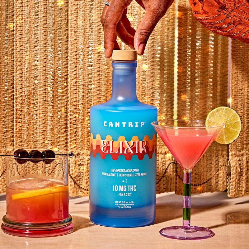 Blue bottle labeled 'Cantarp Elixir' with a cocktail and lime garnish on a textured gold background